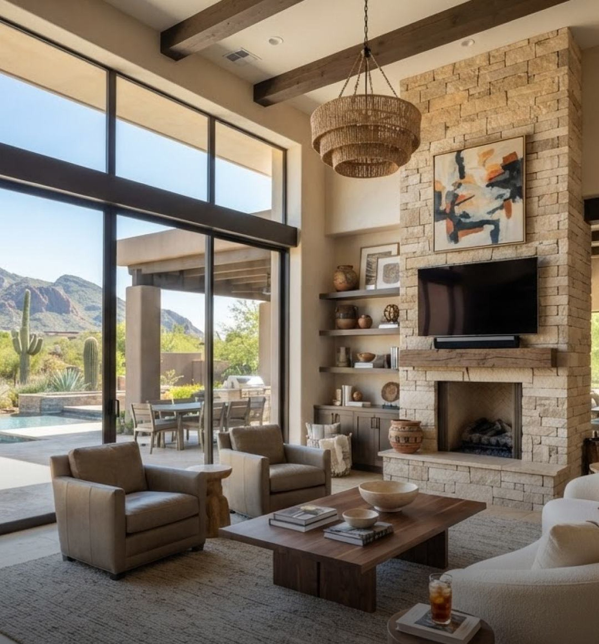 Great room with stone fireplace and desert mountain views in a Scottsdale home